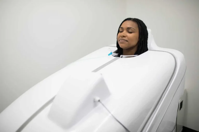 Woman getting HOCATT Sauna session at Embrace Wellness in Bismarck, ND