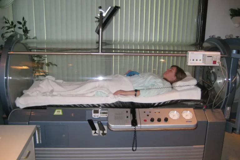 Woman receiving hyperbaric chamber therapy in bismarck, nd at Embrace Wellness