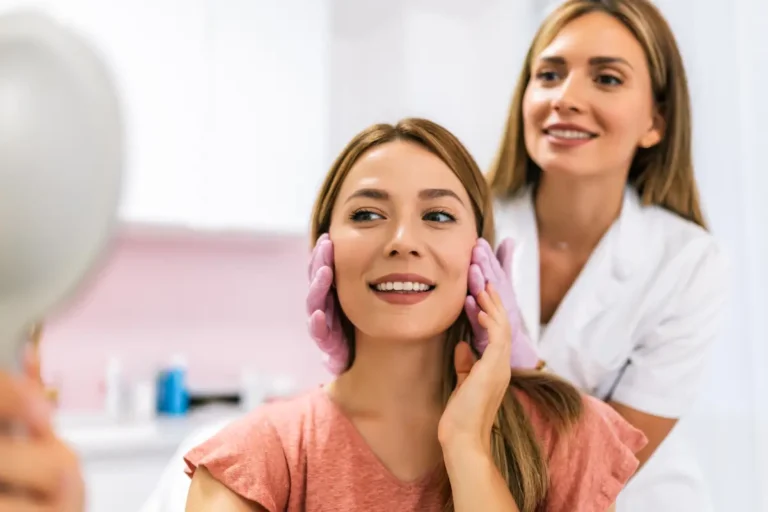 Doctor holding a girl showing her face in Mirror after during yearly checkups session at Embrace Wellness