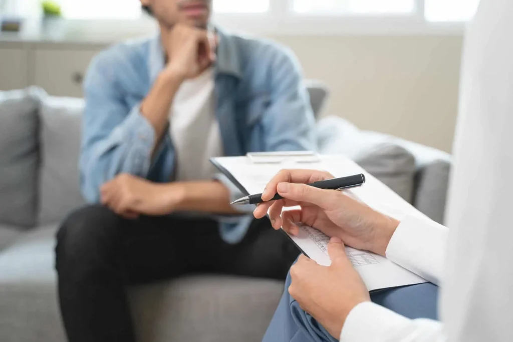 Doctor Prescribing for Anxiety Treatment for a Man sitting infront at Embrace Wellness | Bismarck, ND