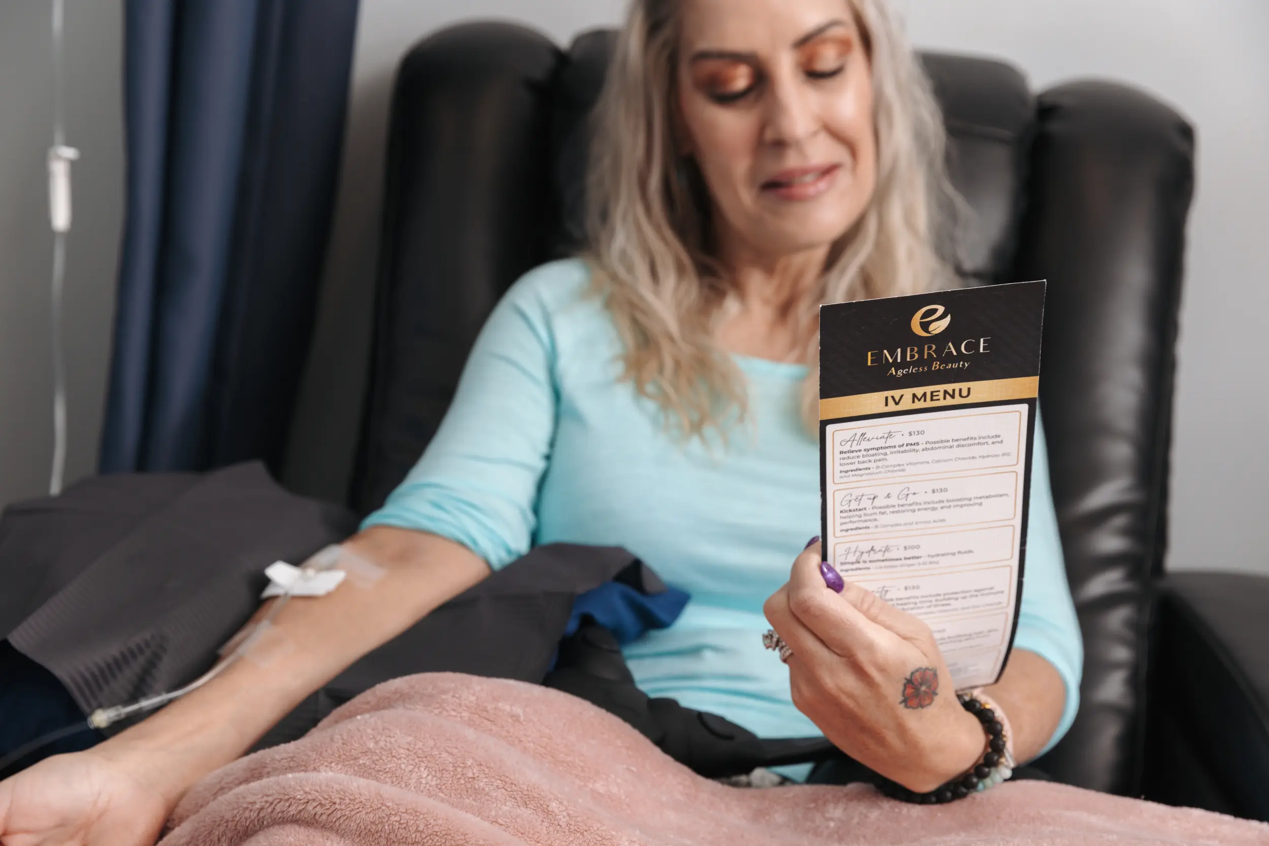 Patient viewing IV therapy menu at medical spa in Bismarck, ND