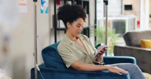 Woman receiving IV therapy while relaxing in a wellness clinic